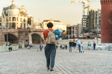 Fototapeta na wymiar traveler with backpack walking in the city Moscow and sunlight with sunset background
