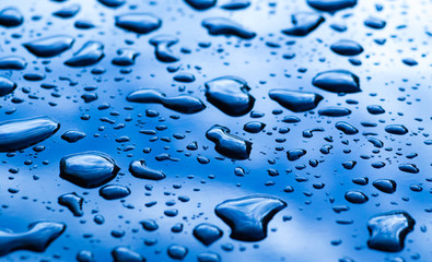 drops of water on the black car after rain - Powered by Adobe