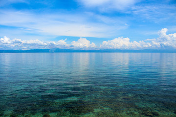 Sea landscape with clouds. Peaceful blue seascape. Tropical seaside minimal photo for wedding background.