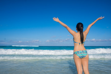 Young girl enjoying her vacations in Cancun beach, Mexico