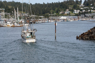 Fishing troller enters  the Yaquina Bay