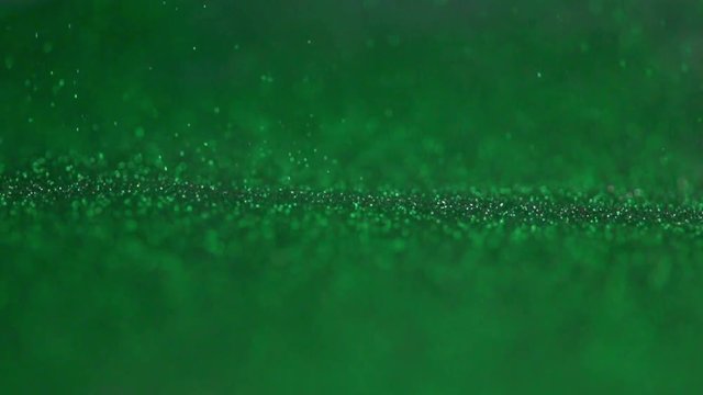 The Green Glitter Falls To The Surface.