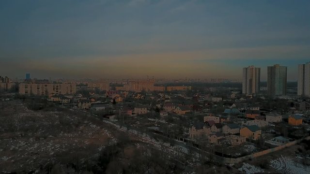 Aerial View, aerial survey drone walk in derelict city park, melting ice crust and perfuse dirt, naked trunks tree,  forgotten place.