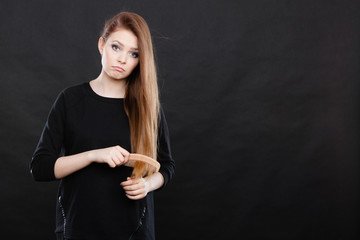 Long haired girl combing her beauty hair.