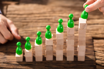 Businessman Arranging The Figures On Block Stack