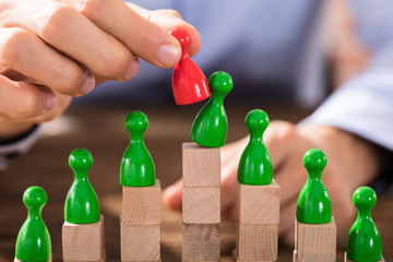 Businessman Replacing The Green Figure With Red Figure