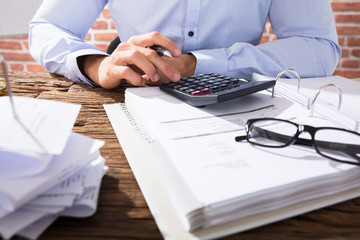Businessperson Calculating Invoice