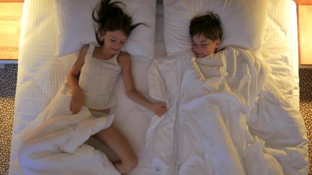 Children sleep in bed. View from above.