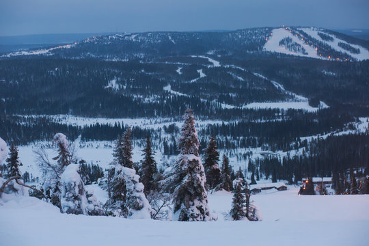 Beautiful cold mountain view of ski resort, sunny winter day with slope, piste and ski lift
