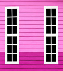 Long window white wood in the pink wall.
