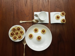 Getting ready for tea with freshly baked pretty yellow pineapple tarts arranged on plate