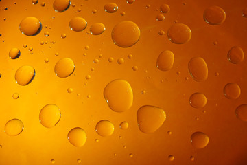 Water Drops On Orange Color Background.