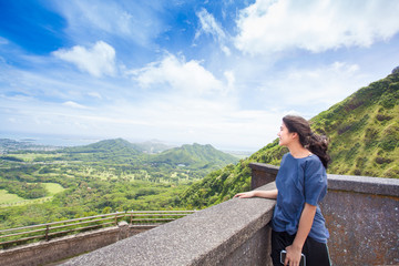 Fototapeta na wymiar Teen girl standing looking out over view of eastern Oahu
