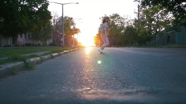 The girl runs across the road in the city in the wrong place. Danger concept. Slow motion.