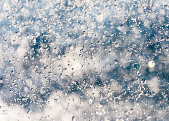 Abstract background of drops of water on the fly