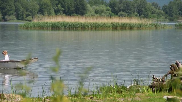 Family time-father and two kids,boy and a girl,enjoying in boat at the river,boy is rowing,Deliblato sands,20th of May 2017.