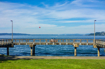 a couple enjoying each others company while watching a para glider on the Tacoma waterfront