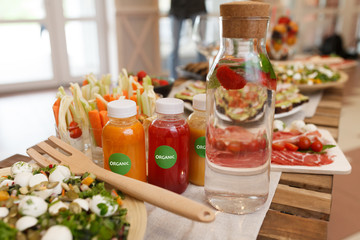 Food table with healthy delicious organic meal concept. People friends celebrate and eat healthy organic meals at served festive wooden table served for party.