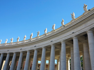 Fototapeta na wymiar Statues and architectural details on Saint Peter square in Vatican