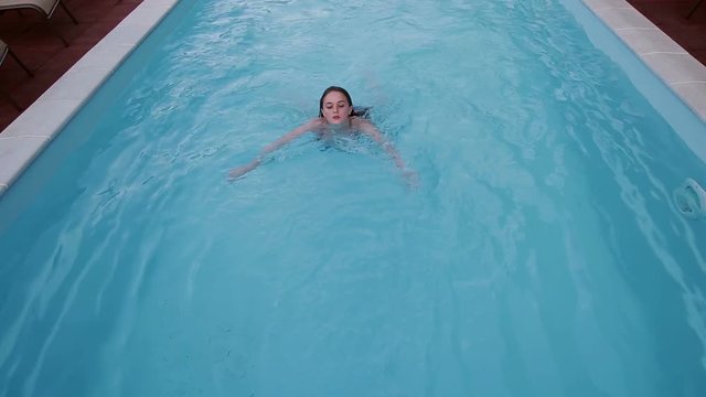 Young Woman is Swimming in the Pool 2