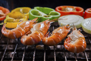 shrimp grilled on barbecue stove with chilly and onion ring