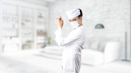 Beautiful medical woman doctor in uniform. Studio painted background. Concept of profitable health care.