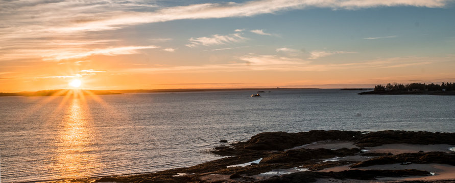 sunrise over the Bay of Fundy near Pocologan and New River Beach in New Brunswick with small tidal pools in the foreground