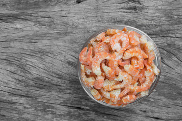 dried shrimp ingredient of many thai food in a glass bowl on old and crack wooden surface, top view