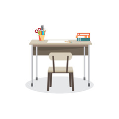 School desk with a chair. On the table are the school supplies. 