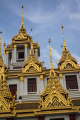 Fototapeta premium Loha Prasat Wat Ratchanatdaram in Bangkok Thailand which means iron castle or monastery is composes of five towers, of which the outer, middle and the center tower contain large black iron spires. 