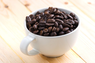 Coffee cup full of coffee beans