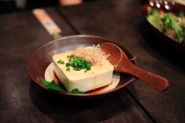 Japan tofu diced dish on wood table in a traditional Japanese restaurant. Healthy food. 
