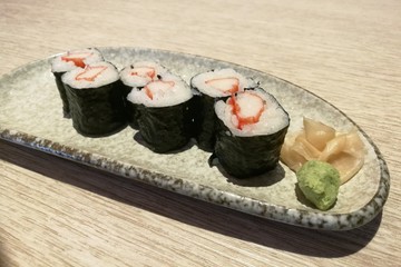 Ebiko maki sushi rolls - japanese food style in a ceramic plate.