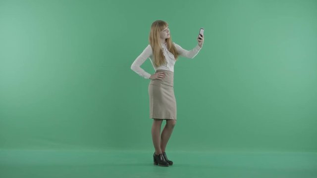 a stylish girl is standing and making selfies