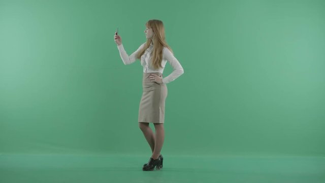 a woman in skirt takes photos of herself
