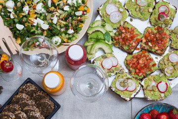 Food table with healthy delicious organic meal concept. People friends celebrate and eat healthy organic meals at served festive wooden table served for party.