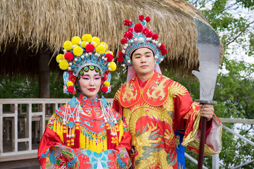 asian man and woman in traditional red chinese costumes