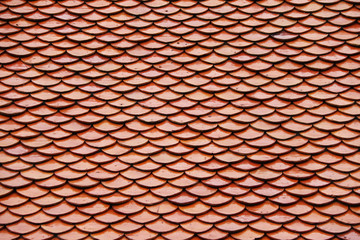 Pattern of Thai terracotta roof, red brown color. The pattern look like a fish scales.