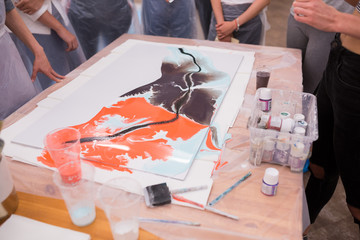 Attractive group of mixed race diverse women artists bonding and unplugging with art therapy. Drawing technique with liquid acrylic, artistic ground, liquid and dry pigments