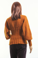 Girl-mannequin in a bright orange jacket (view from the back)
