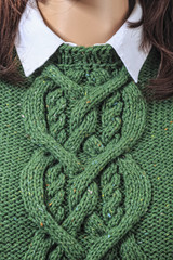Knitted green sweater on a mannequin close-up