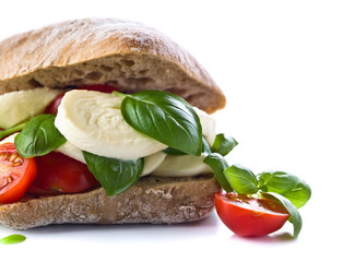 Ciabatta with mozzarella, tomato and basil isolated on white