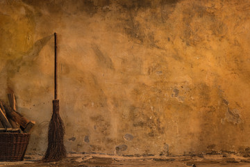 The vintage yellow wall with broom and fire wood - 164249091