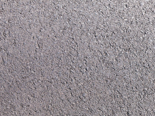 The texture of the surface of the asphalt road for use as a background. Consists of fine gravel and...