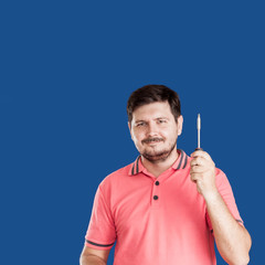 Handsome caucasian 30 years old man  with Screwdriver on blue background