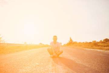 Young man smiling and enjoying sunny summer day