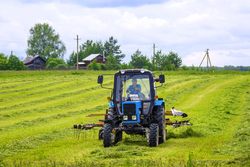 Tractor on the field. Hay making