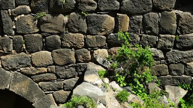 Camera showing an ancient brick wall of armenian fortress Amberd and window in it with beautiful view