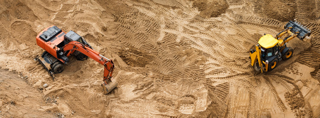 Construction of concrete foundation of new building. Construction machinery, excavators, top view, banner for website.