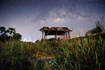 Milkyway over the outdated hut  in the early of night at Muadzam Shah, Pahang, Malaysia ( Visible...
